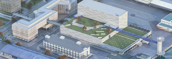 Die Mitte des Bildes zeigt die neue Tiefkühl- und Pharmahalle mit begrünter Teil-Dachfläche.